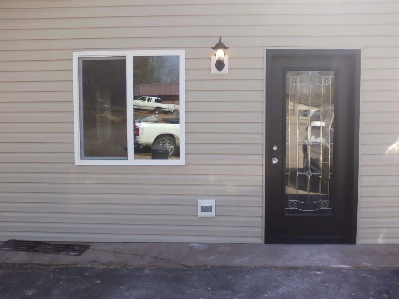 New siding, window and entry door on the side of an addition in Holiday